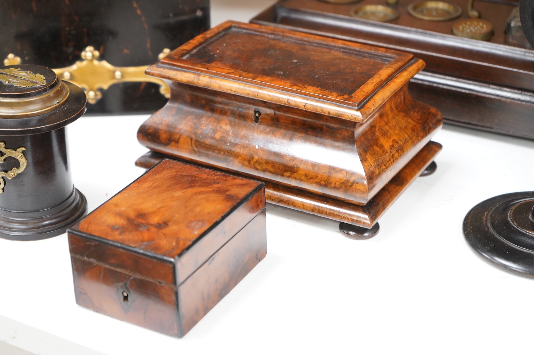 A collection of sundry items to include a Coromandel and brass mounted ink blotter pad, an early 19th century French yew veneered travelling writing box, an early 19th century mahogany desk stand and burr walnut bombé sh